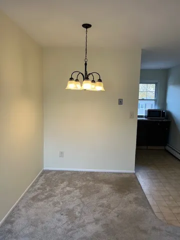 a view of a chandelier fan and a window in a room