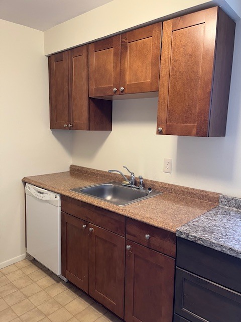 100 Silliman Street, Unit 1B Fairfield, CT 06824 - Photo 8 of 25 a kitchen with granite countertop cabinets and sink