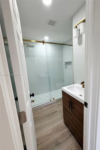 a bathroom with a sink and shower