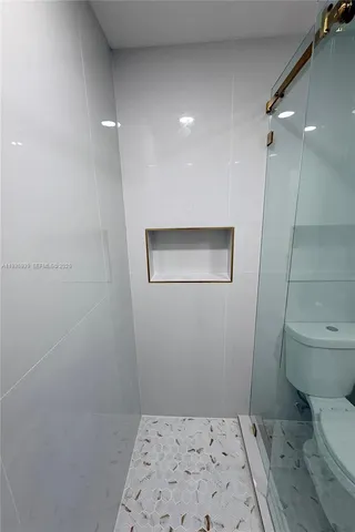 a bathroom with a toilet and a shower