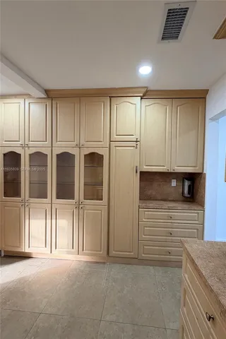 a view of a livingroom with an empty space and more windows