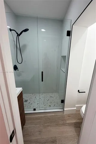 a bathroom with a shower and a sink