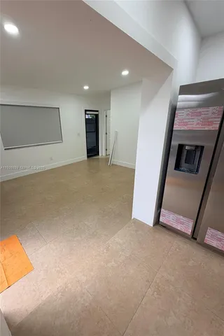 a view of an empty room with a fireplace