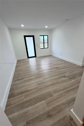 a view of wooden floor and windows in a room