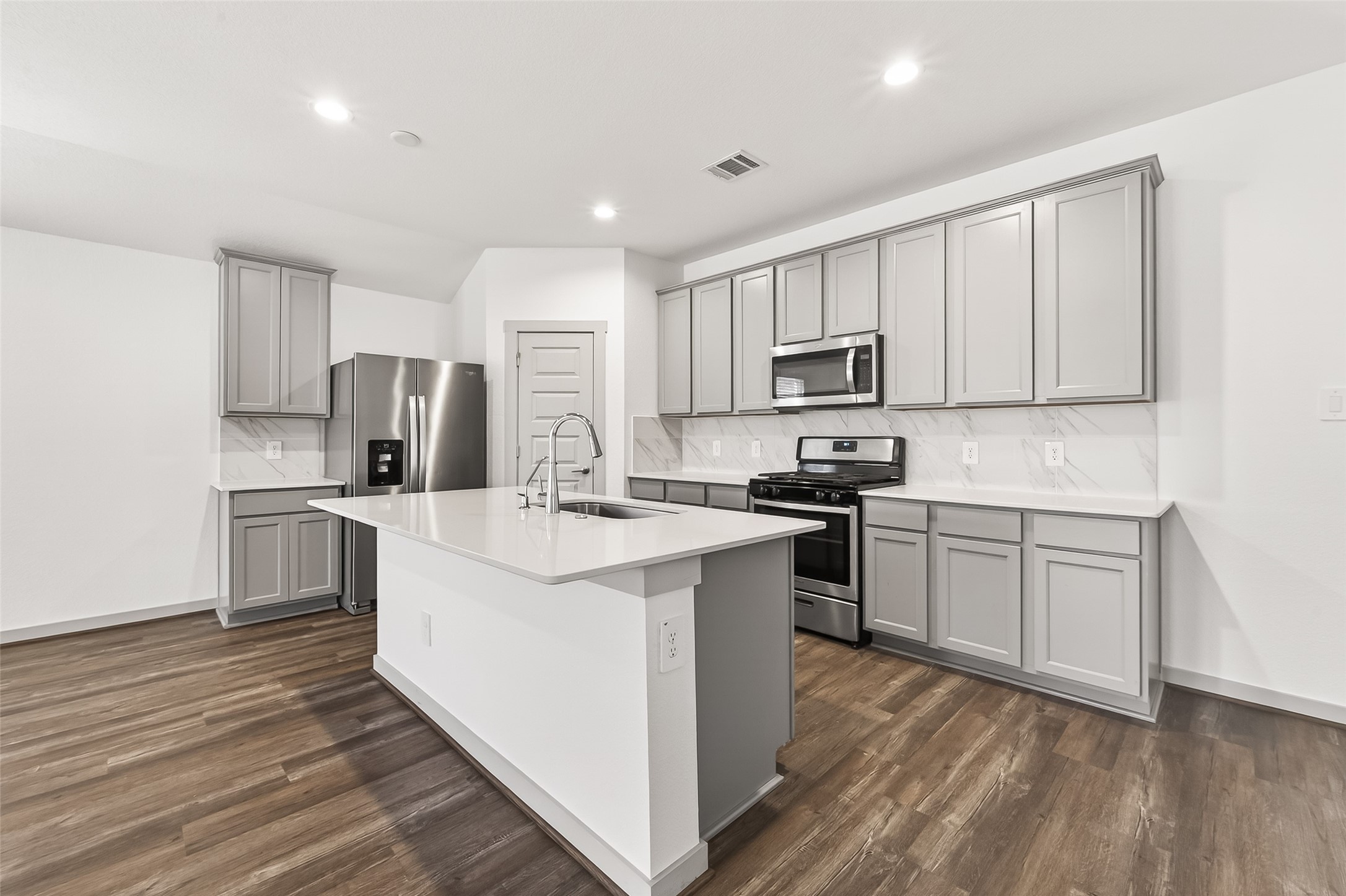 6807 Bradford Terrace Road Richmond, TX 77407 - Photo 3 of 40 a kitchen with cabinets stainless steel appliances and sink