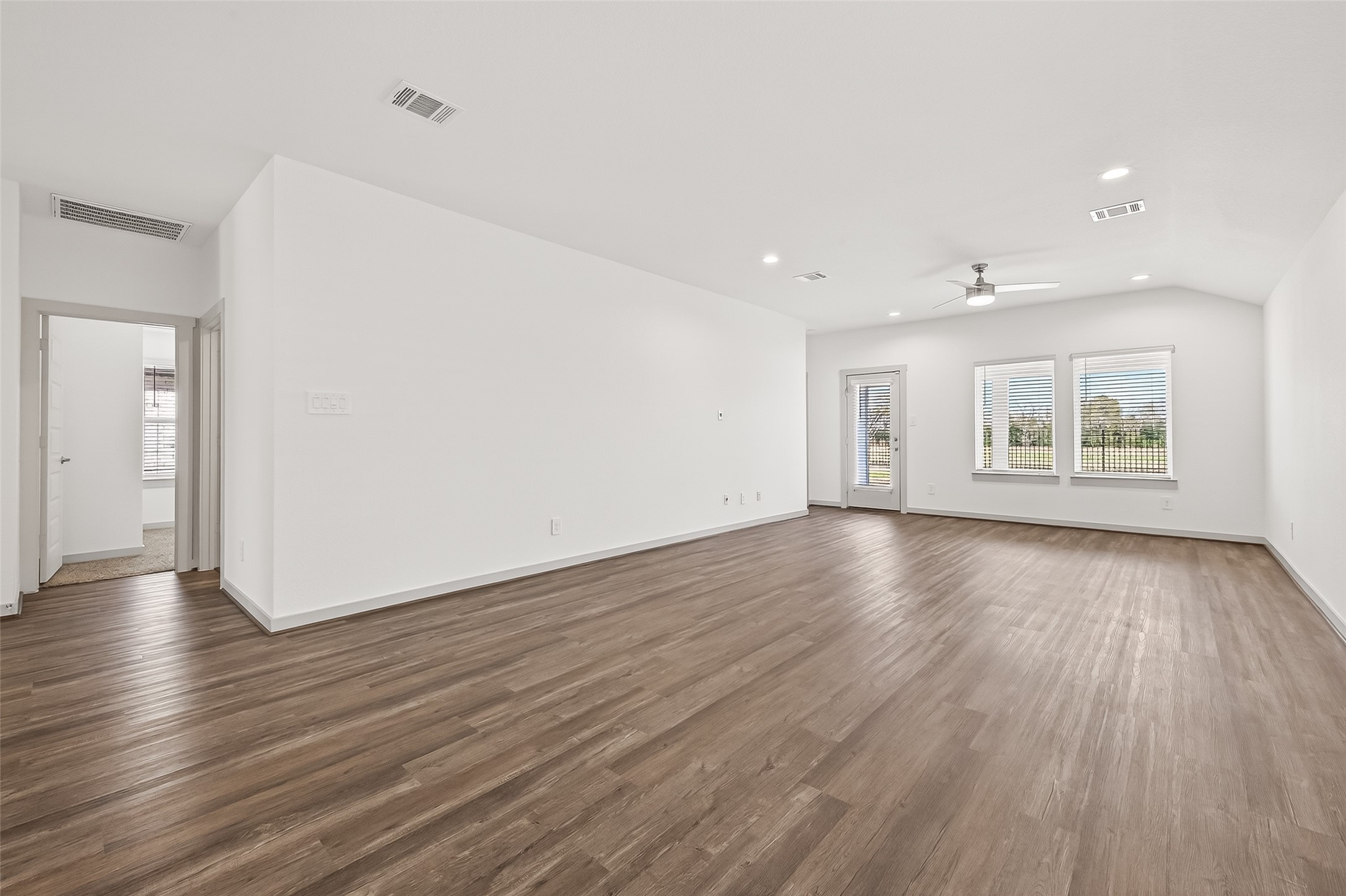 6807 Bradford Terrace Road Richmond, TX 77407 - Photo 4 of 40 an empty room with wooden floor and windows