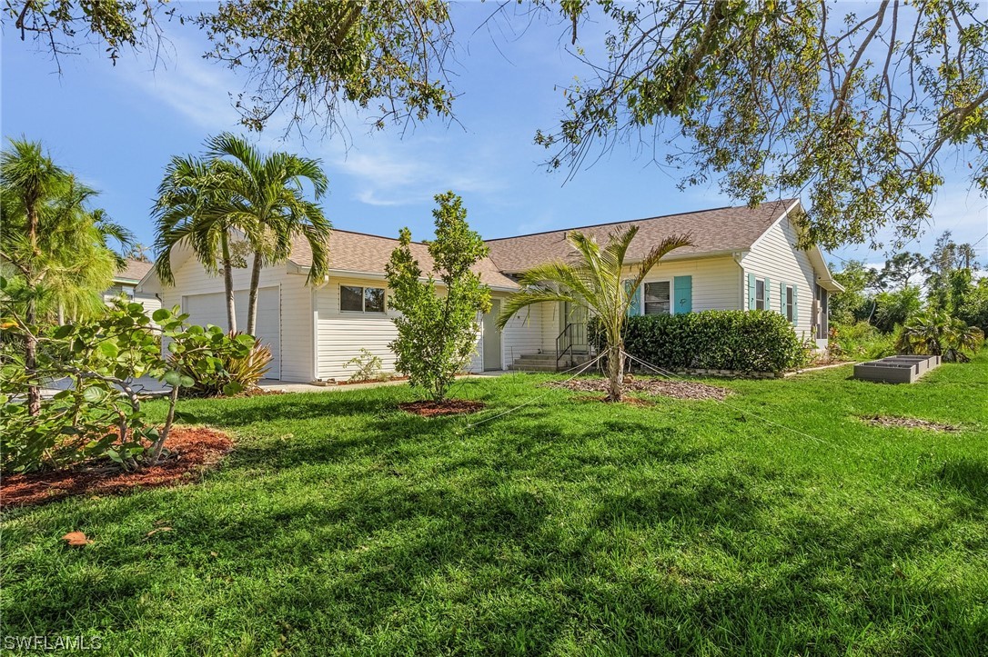 13673 Hampton Road Bokeelia, FL 33922 - Photo 1 of 28 a view of a house with a yard