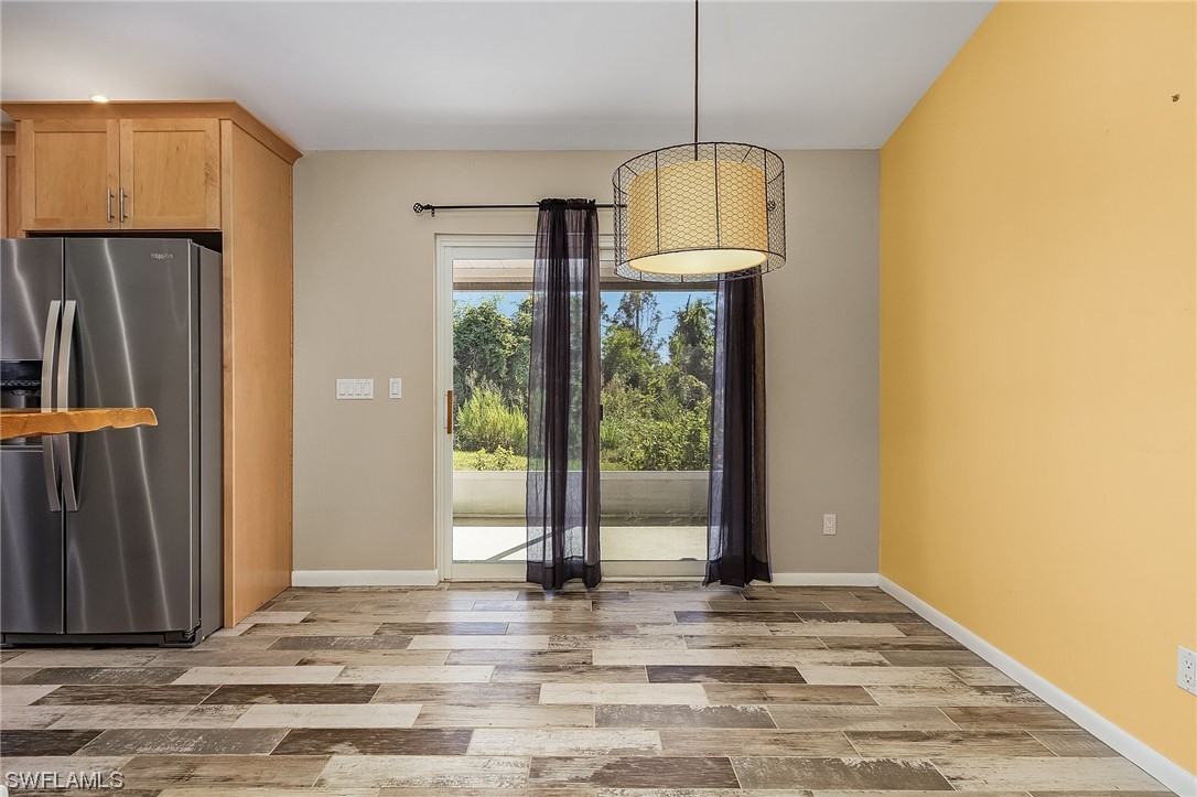 13673 Hampton Road Bokeelia, FL 33922 - Photo 13 of 28 a view of empty room with wooden floor and window