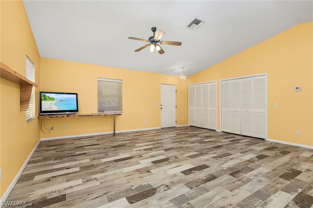 13673 Hampton Road Bokeelia, FL 33922 - Photo 15 of 28 a view of a livingroom with a hall and a ceiling fan