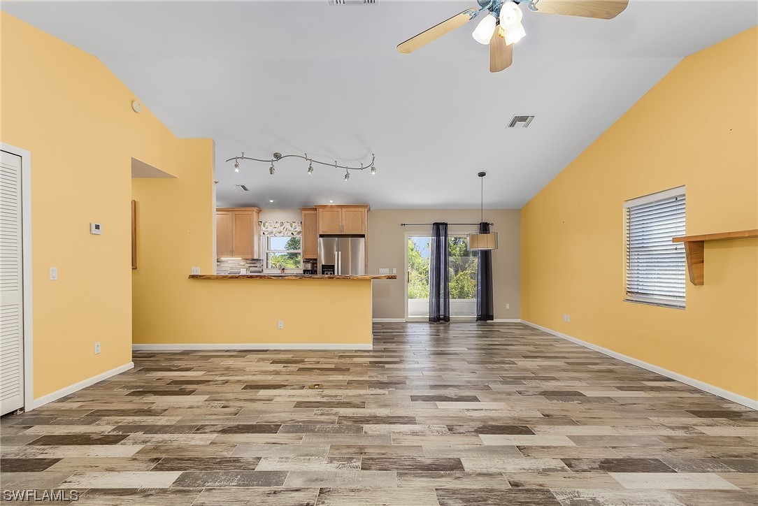 13673 Hampton Road Bokeelia, FL 33922 - Photo 16 of 28 a view of kitchen and hall with wooden floor