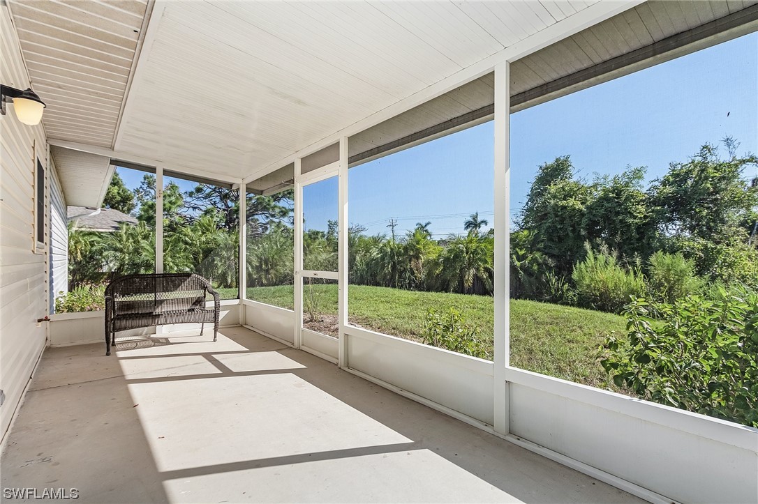 13673 Hampton Road Bokeelia, FL 33922 - Photo 22 of 28 a view of a porch with furniture and garden