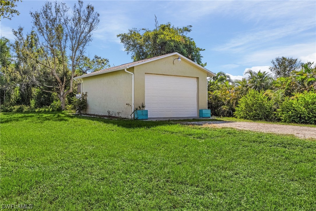 13673 Hampton Road Bokeelia, FL 33922 - Photo 23 of 28 a front view of house with garden