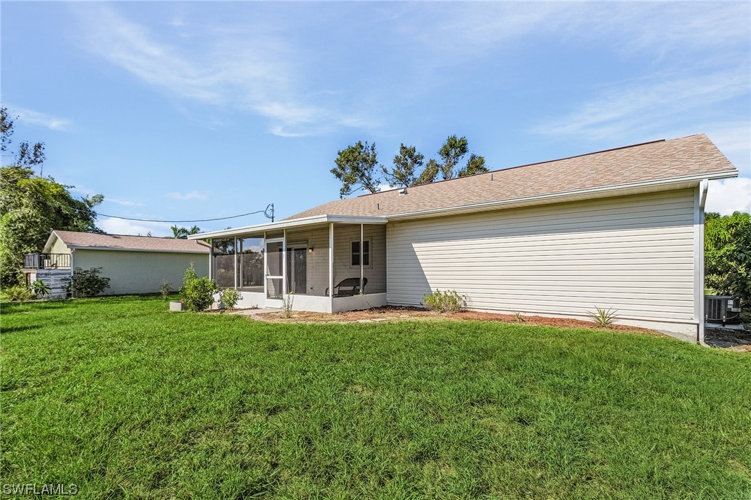 13673 Hampton Road Bokeelia, FL 33922 - Photo 3 of 28 front view of a house with a yard
