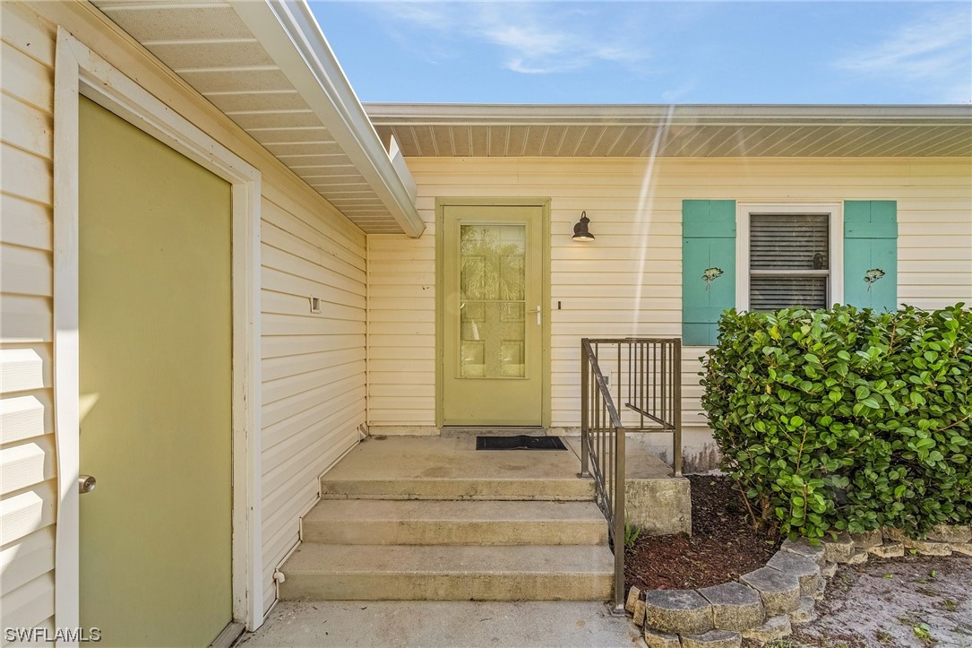 13673 Hampton Road Bokeelia, FL 33922 - Photo 5 of 28 a view of the entrance door of the house