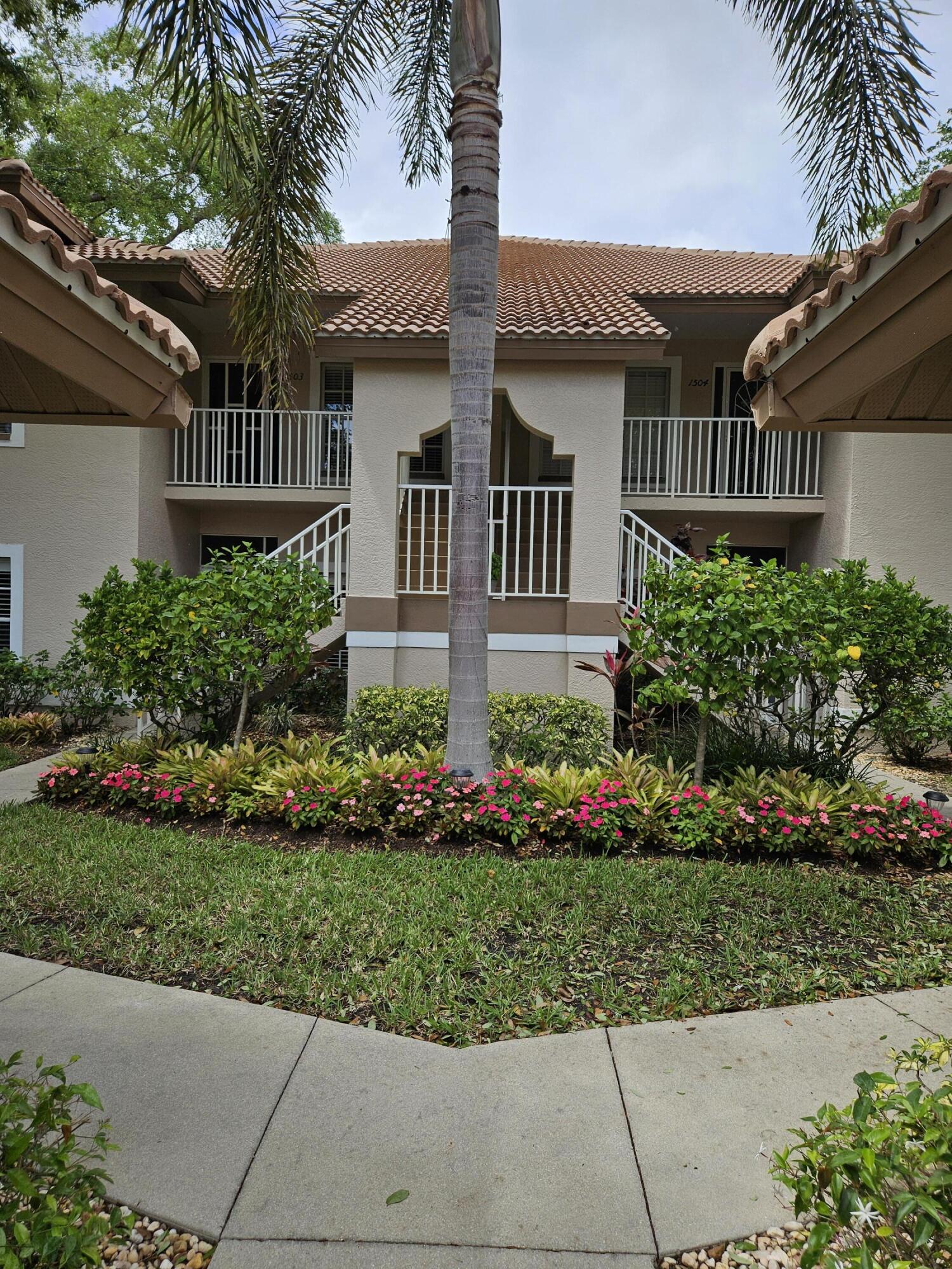 8083 Panther Trail, Unit 1501 Naples, FL 34113 - Photo 2 of 3 a front view of a house with a yard