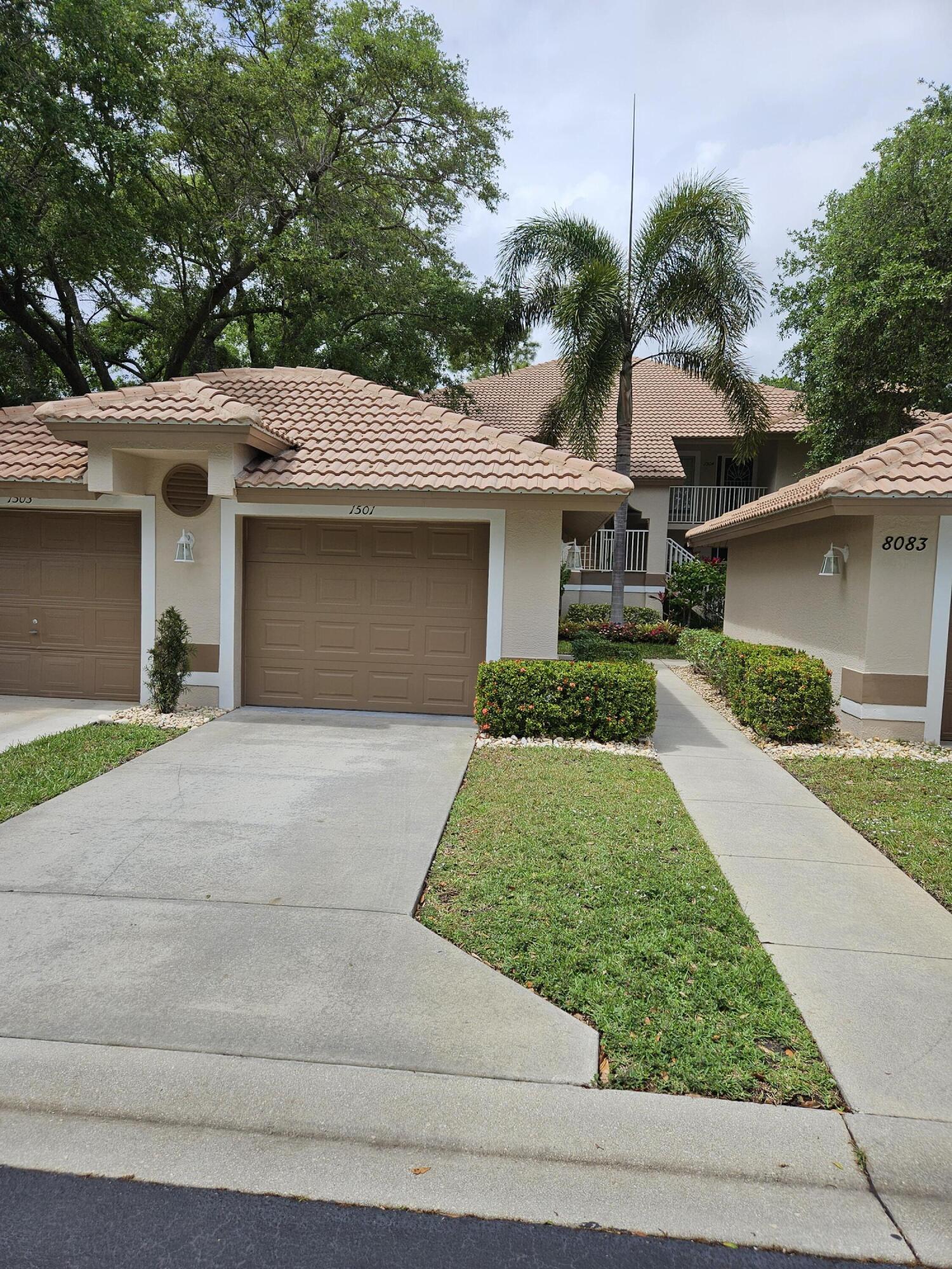 8083 Panther Trail, Unit 1501 Naples, FL 34113 - Photo 3 of 3 a front view of a house with garden