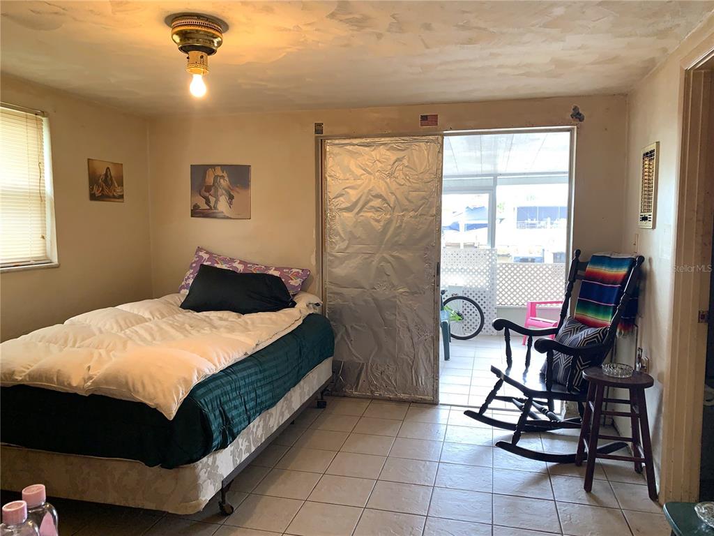 12629 1st Isle Hudson, FL 34667 - Photo 13 of 29 a bedroom with a bed a table and chair