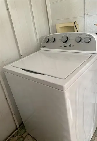 a front view of a house with a garden and yard