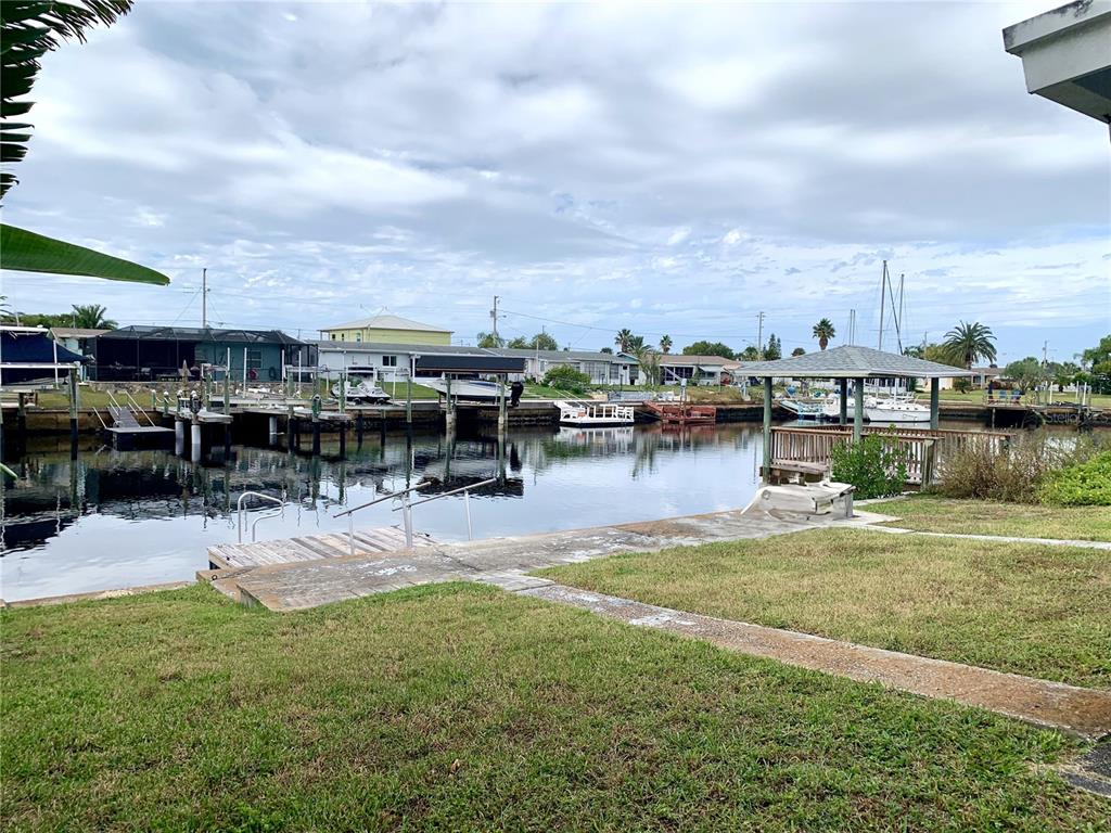 12629 1st Isle Hudson, FL 34667 - Photo 19 of 29 a view of a lake with houses in the back