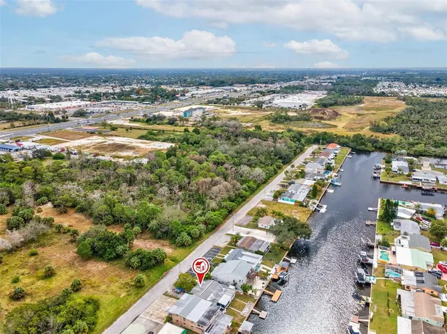 an aerial view of residential houses with outdoor space and swimming pool