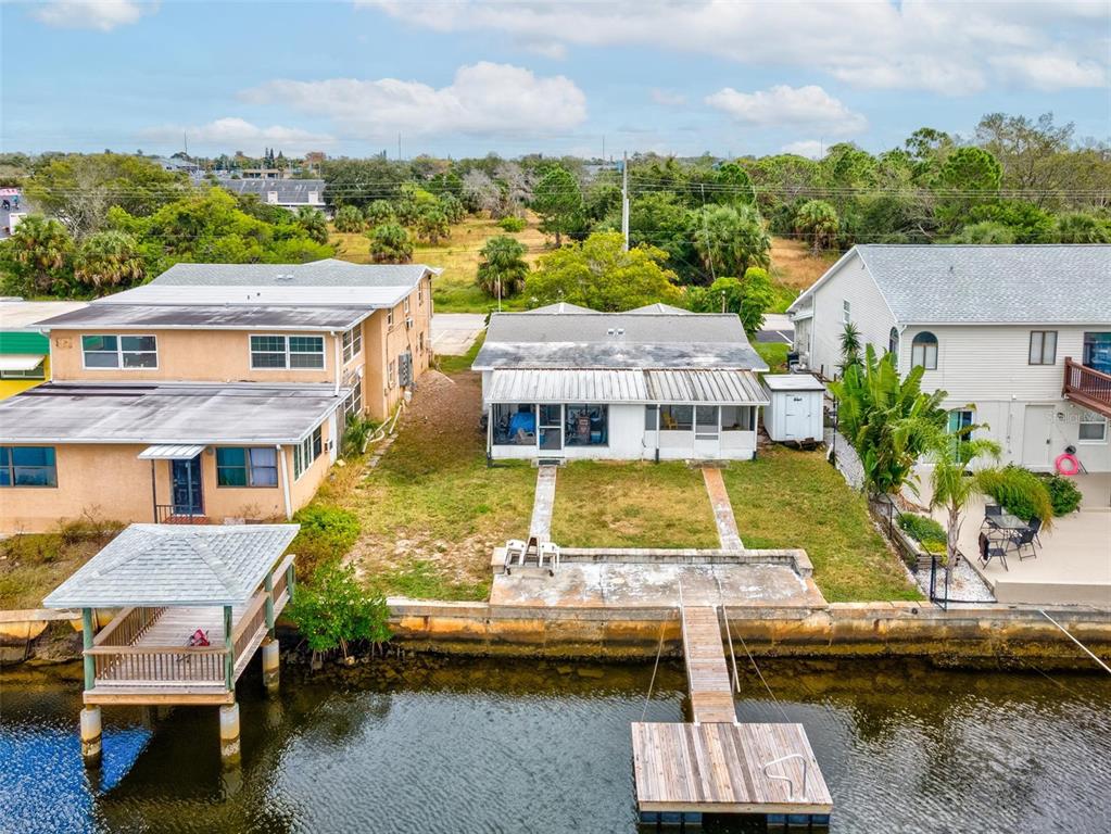 12629 1st Isle Hudson, FL 34667 - Photo 26 of 29 a aerial view of a house with swimming pool lawn chairs and large trees