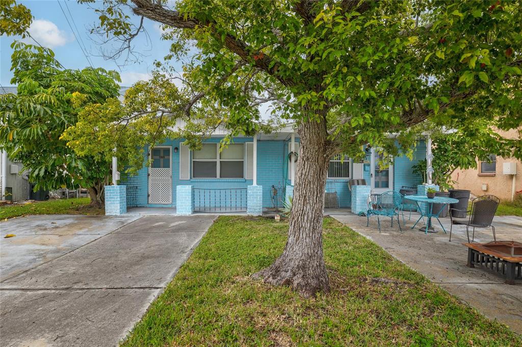 12629 1st Isle Hudson, FL 34667 - Photo 29 of 29 a front view of a house with a garden and trees