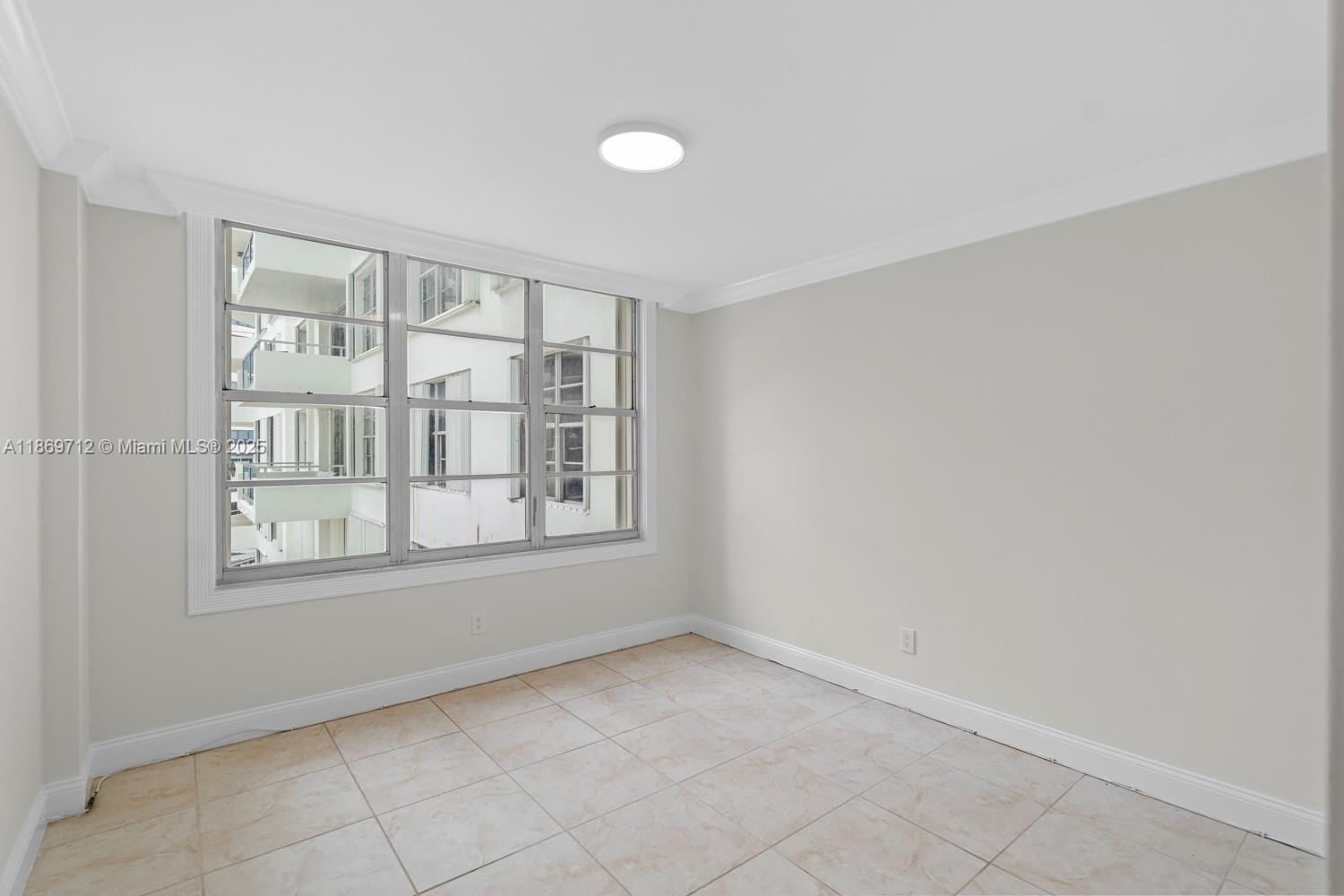 5161 Collins Avenue, Unit 701 Miami Beach, FL 33140 - Photo 17 of 47 an empty room with windows