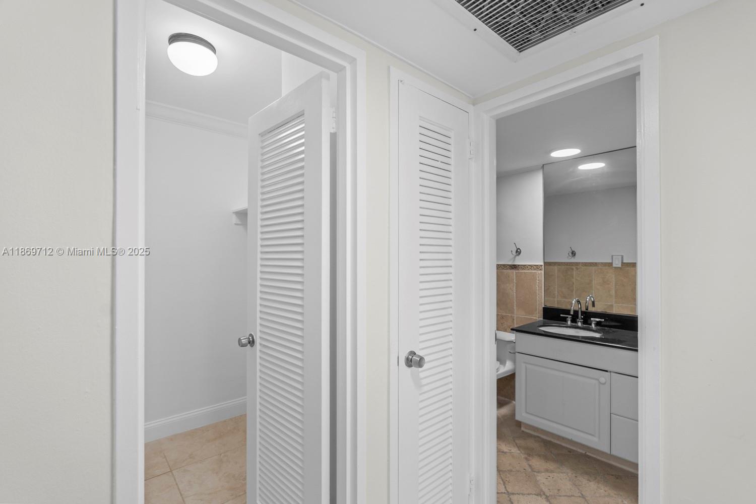 5161 Collins Avenue, Unit 701 Miami Beach, FL 33140 - Photo 26 of 47 a bathroom with a walk in closet and a window