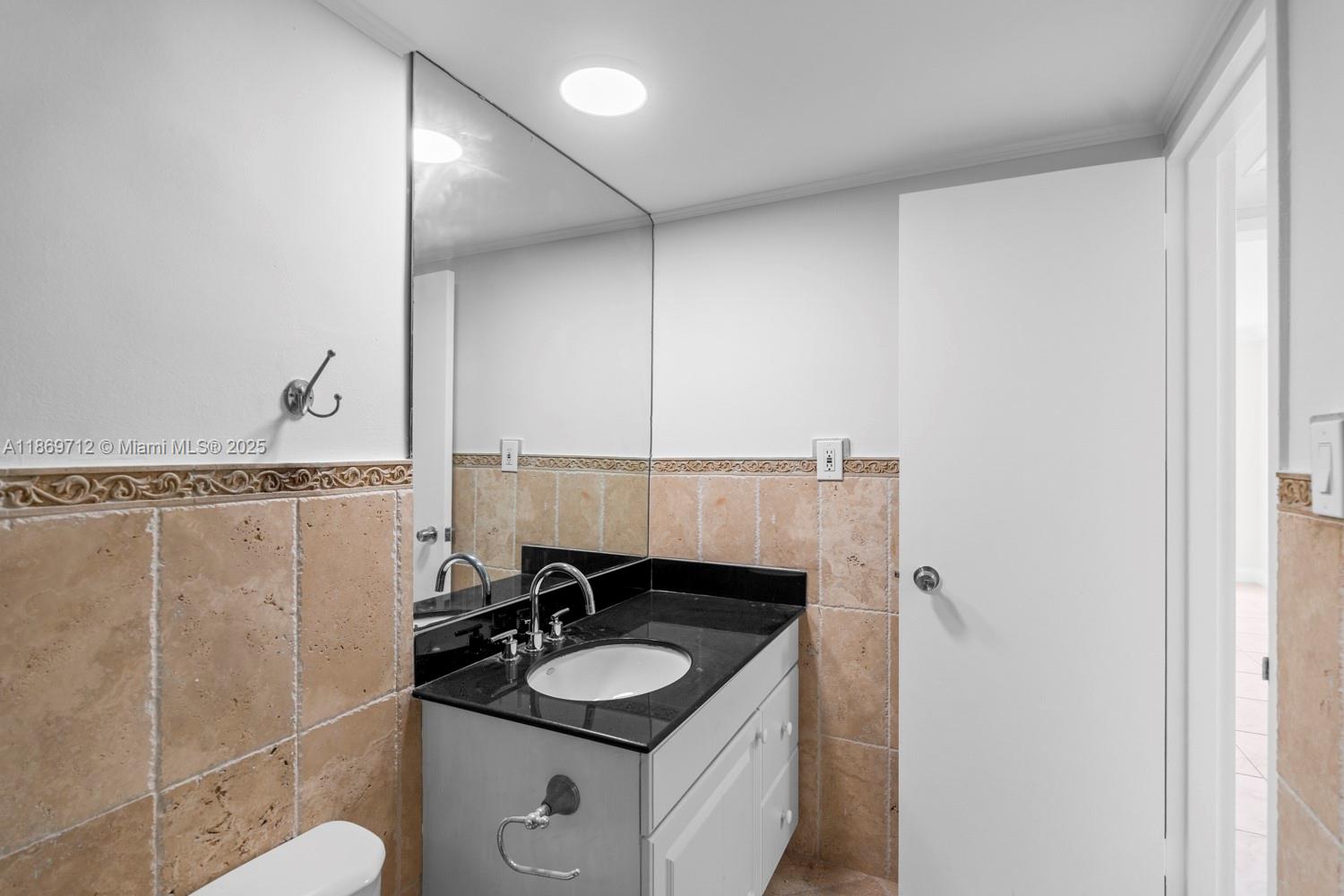 5161 Collins Avenue, Unit 701 Miami Beach, FL 33140 - Photo 28 of 47 a bathroom with a sink and a mirror