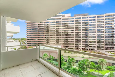 a view of a tall building next to a yard