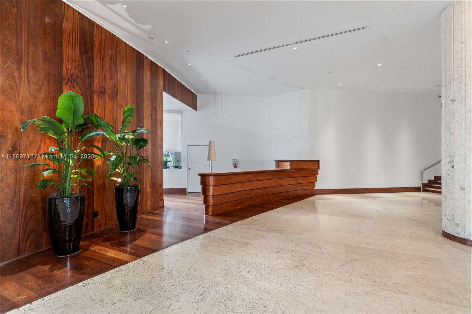 5161 Collins Avenue, Unit 701 Miami Beach, FL 33140 - Photo 37 of 47 a room with wooden floor and a potted plant