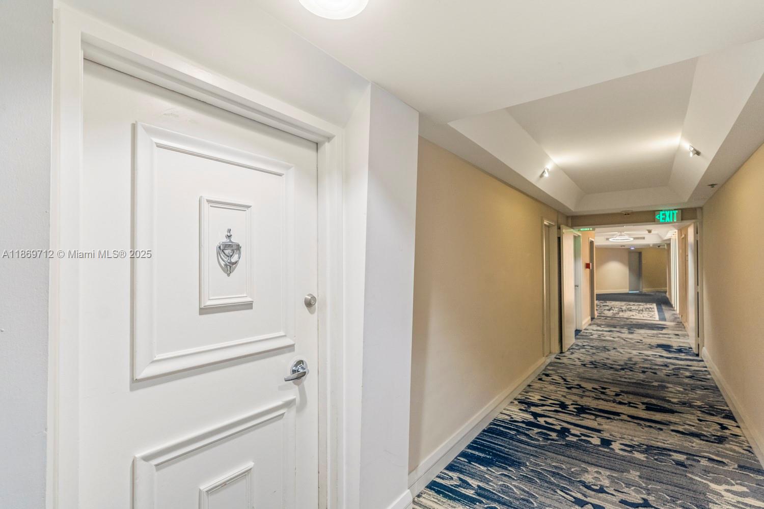 5161 Collins Avenue, Unit 701 Miami Beach, FL 33140 - Photo 43 of 47 a view of a hallway view with wooden floor and staircase