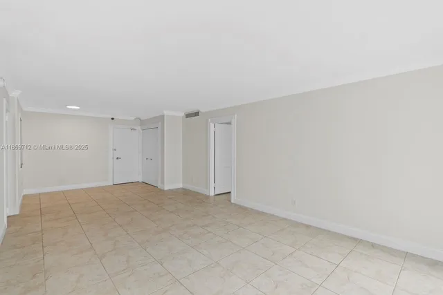 a view of an empty room and closet area