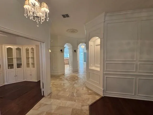 a view of a hallway with entryway windows and dinning room