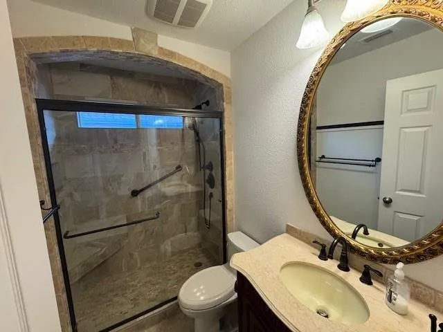 a bathroom with a sink toilet and shower