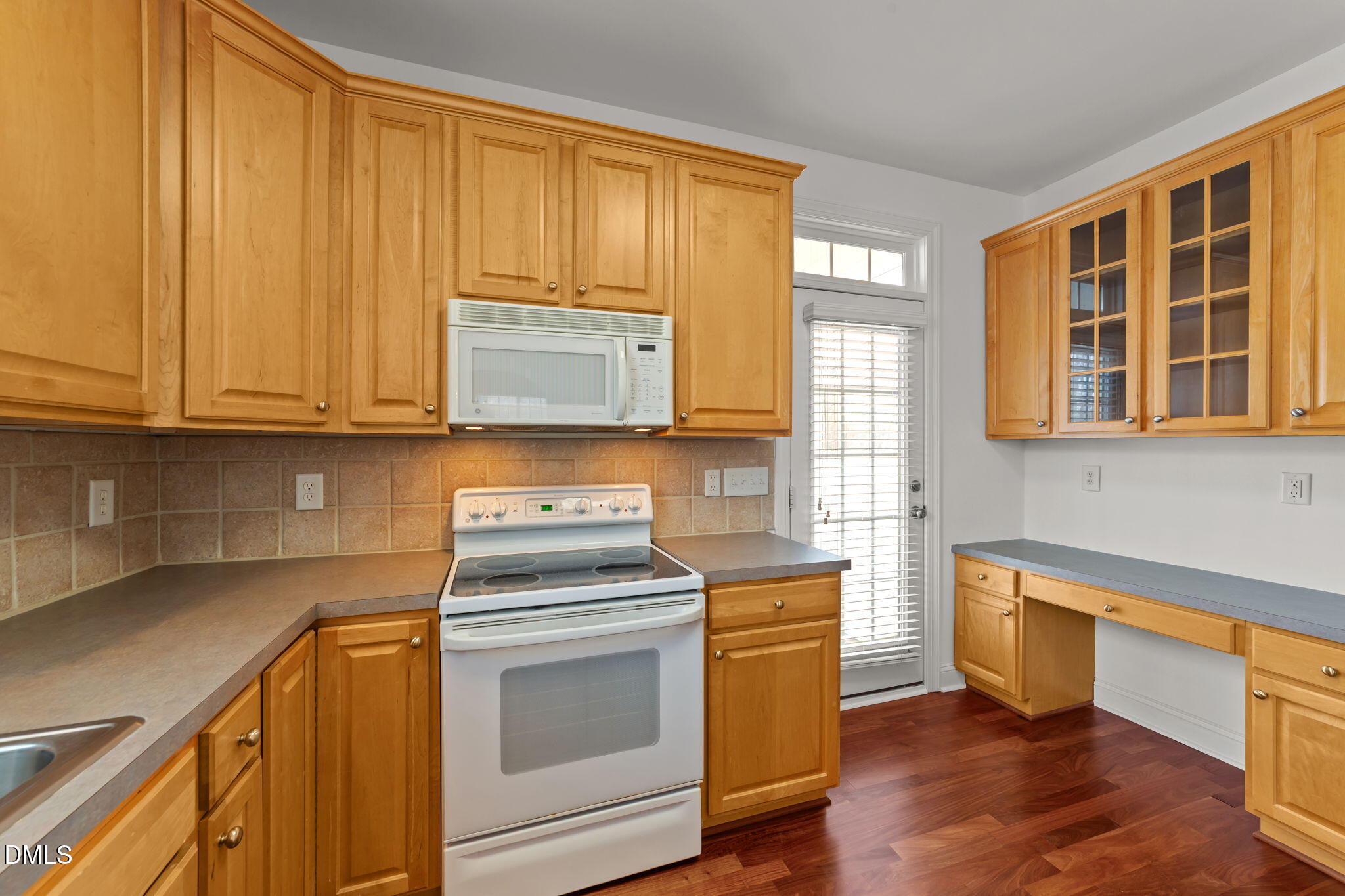 7101 Numa Circle Willow Spring, NC 27592 - Photo 12 of 44 a kitchen with stainless steel appliances wooden cabinets and a stove top oven