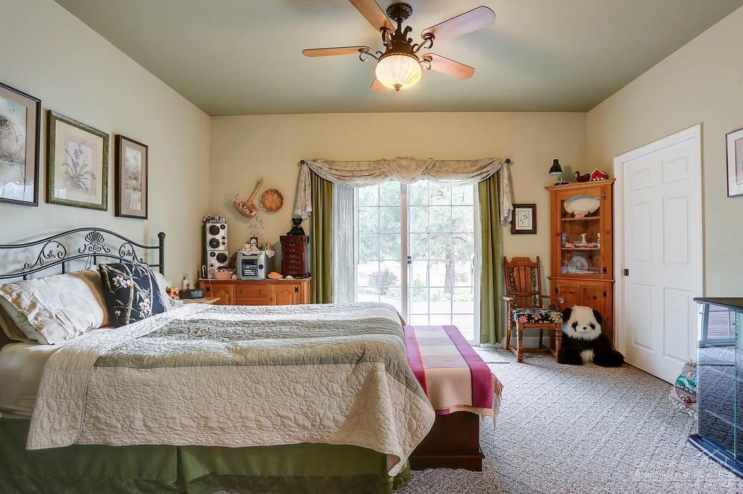 60031 Hopi Road Bend, OR 97702 - Photo 7 of 20 a bedroom with a bed and ceiling fan