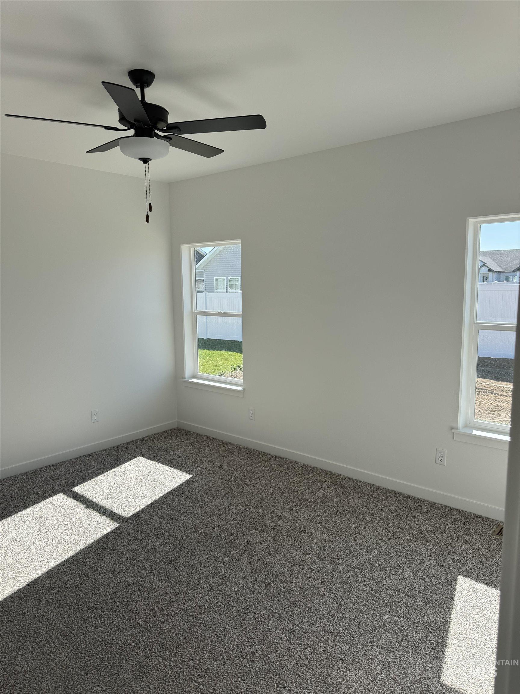 1295 Starlight Loop Twin Falls, ID 83301 - Photo 8 of 11 Carpeted empty room featuring baseboards and ceiling fan