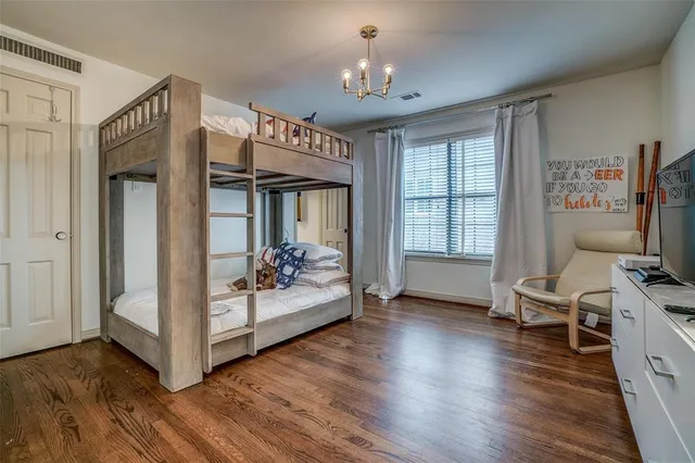 a view of a livingroom with wooden floor and a ceiling fan