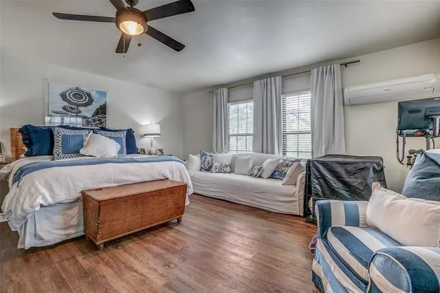 a spacious bedroom with a bed a couch and a window