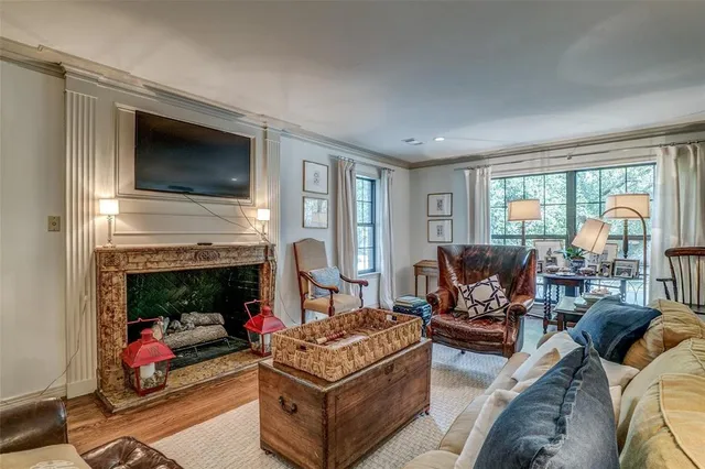 a living room with furniture a flat screen tv and a fireplace