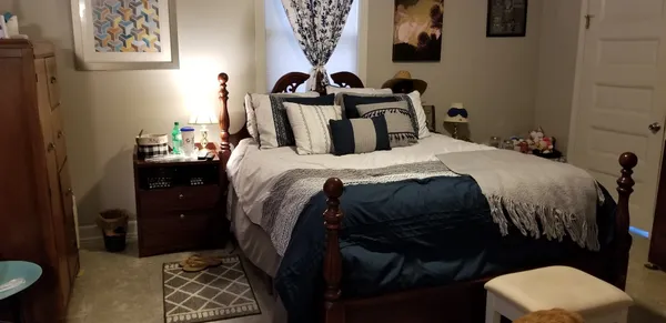 a bedroom with a bed and a window