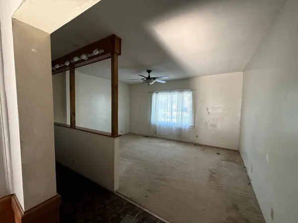 an empty room with windows and closet