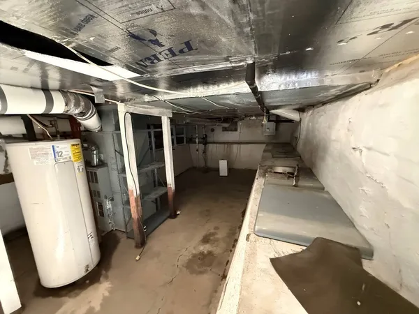 a view of water heater room with refrigerator