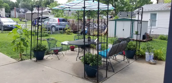 a view of a chairs and table in backyard of the house