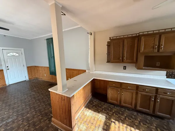 a kitchen with stainless steel appliances granite countertop a sink and a stove top oven with wooden floor