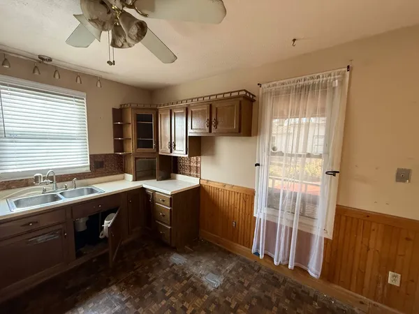 a kitchen with a sink appliances and cabinets
