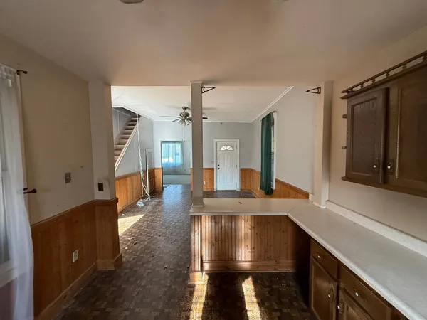 a view of kitchen with cabinets and wooden floor