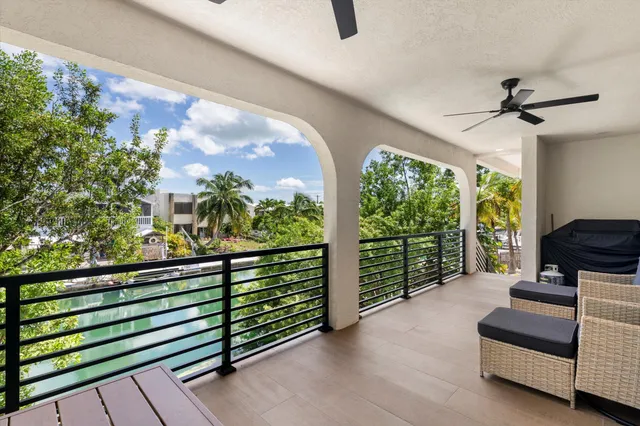 a balcony with furniture and a potted plant