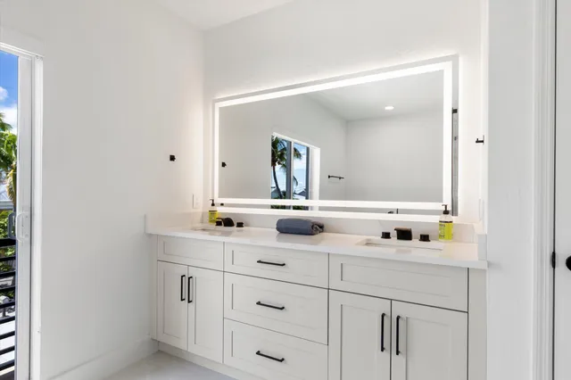 a bathroom with a double vanity sink and mirror